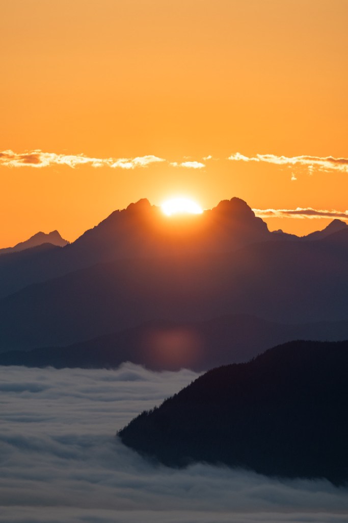 sun setting over mountains